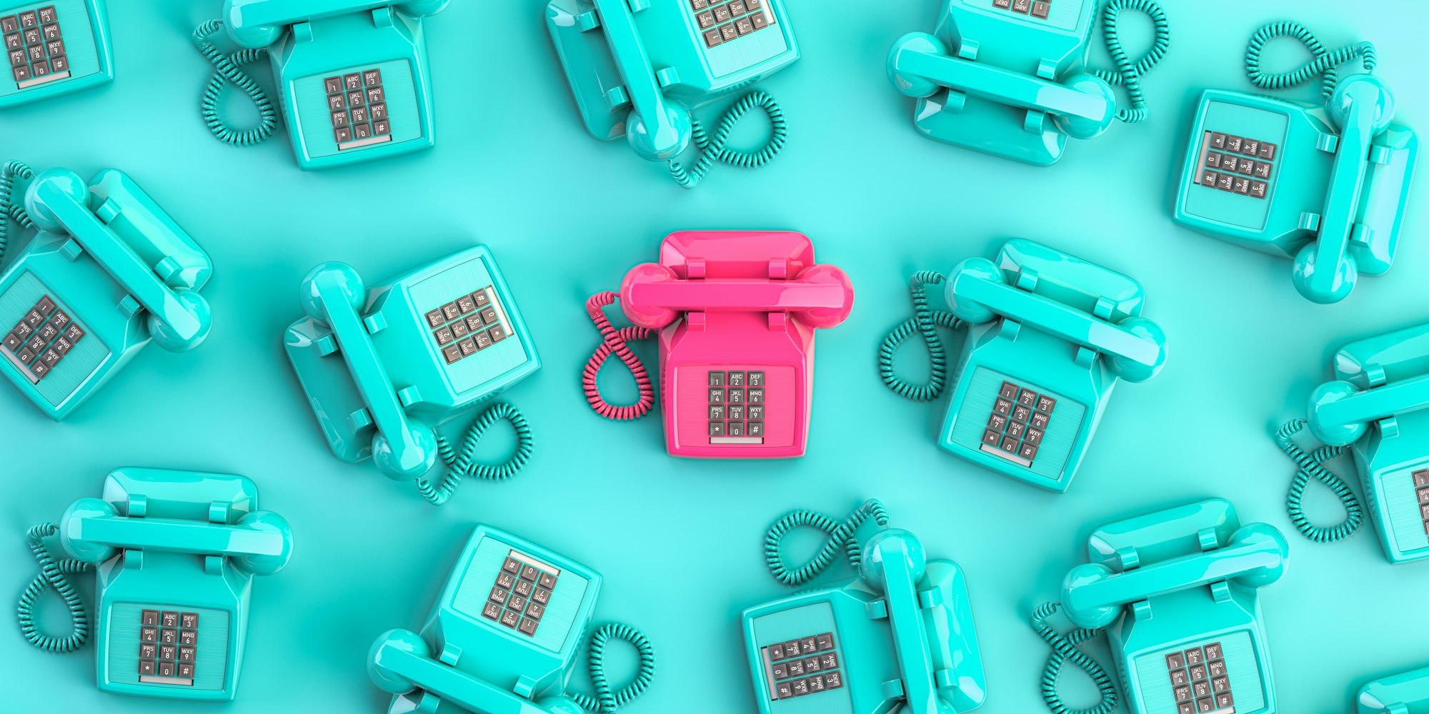 Pink vintage telephone on background from blue retro telephones.
